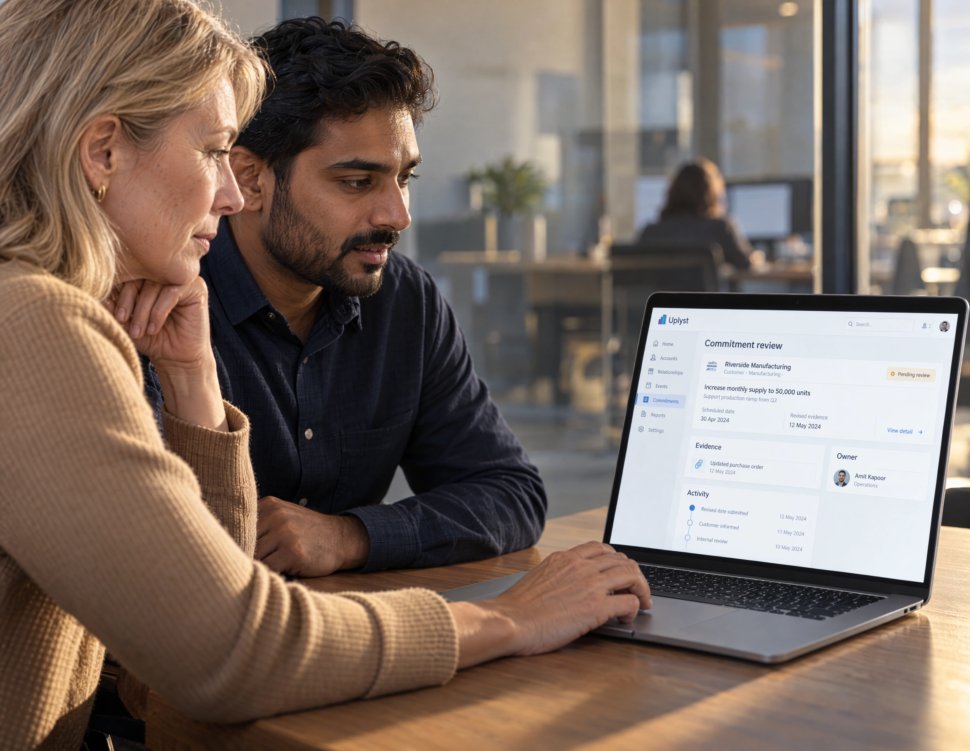 A finance lead and operations colleague compare a commercial exception in a shared business review.