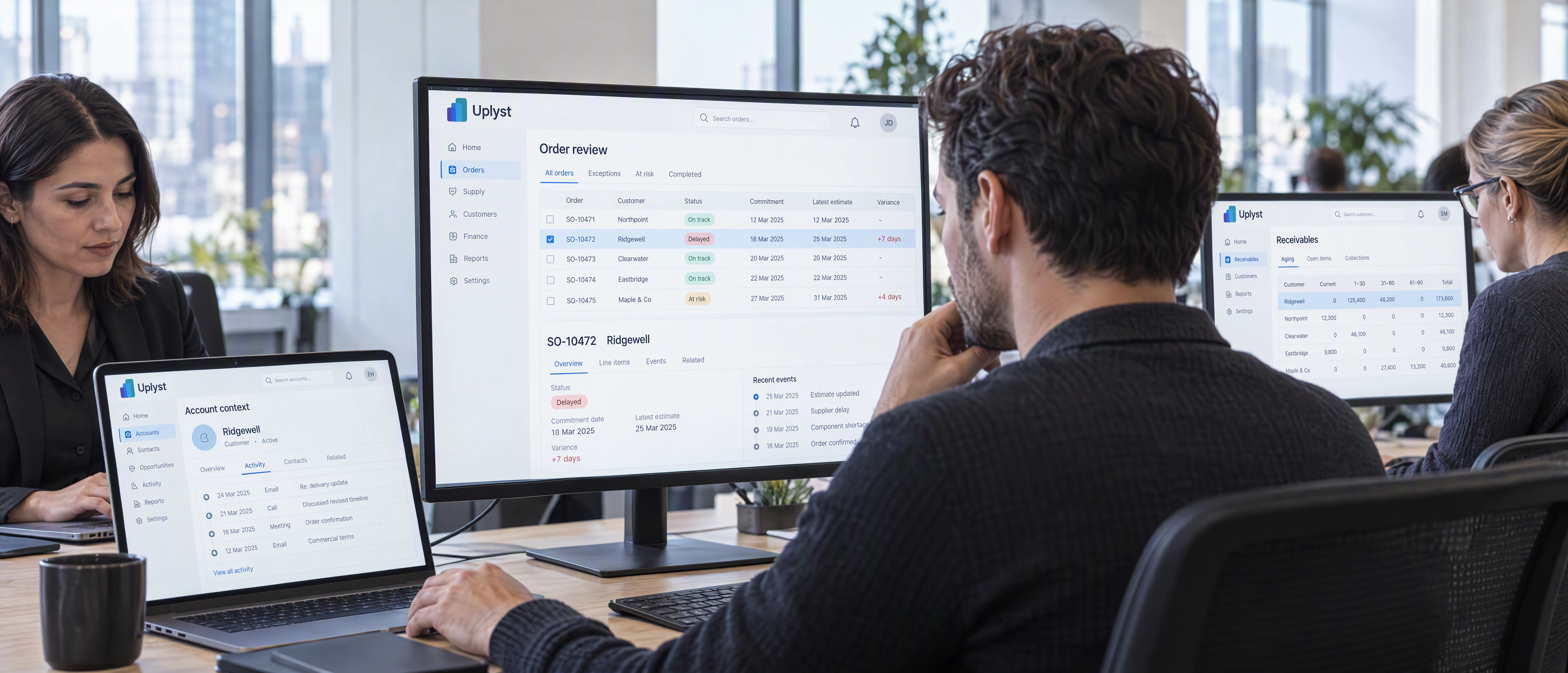 An operations planner and commercial colleagues examine connected order, customer and finance information at their workstations.