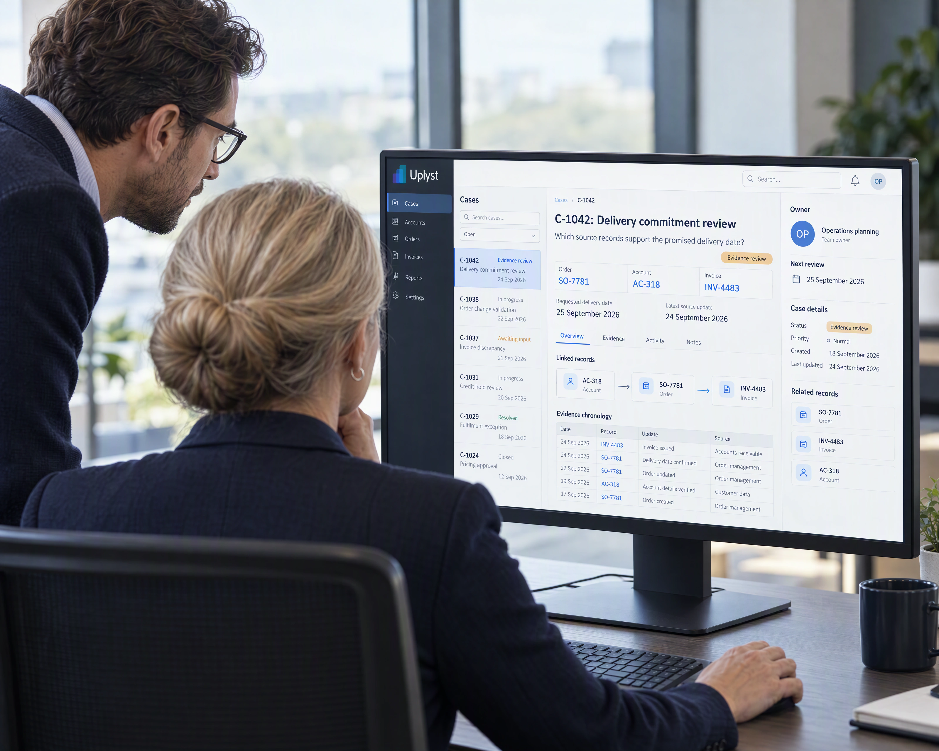 A business owner and an architect examine a connected operating case at a shared workstation.